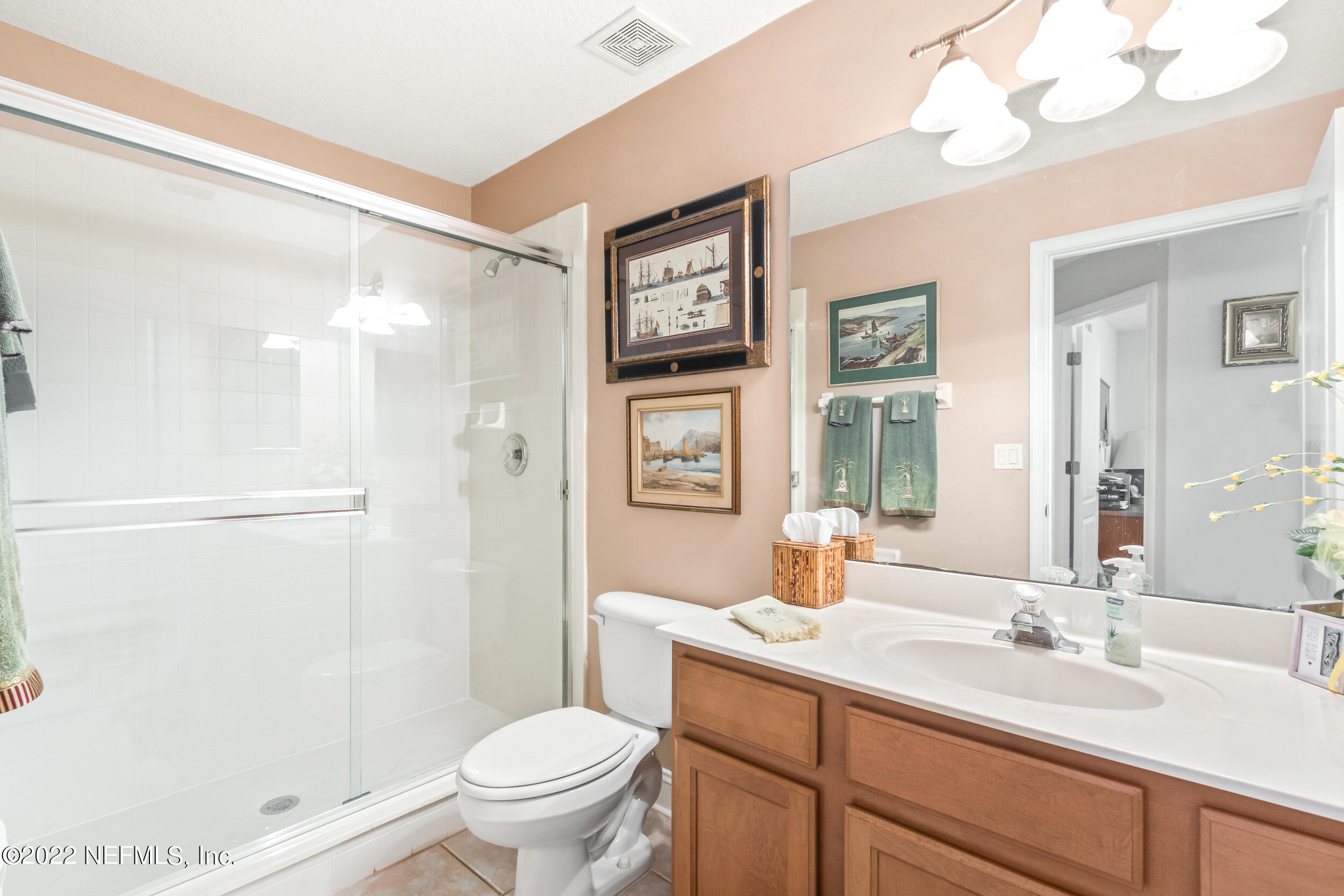 1304 Paradise Pond Road St. Augustine, FL 32092 - Photo 32 of 48 a bathroom with a sink a toilet a large mirror and shower