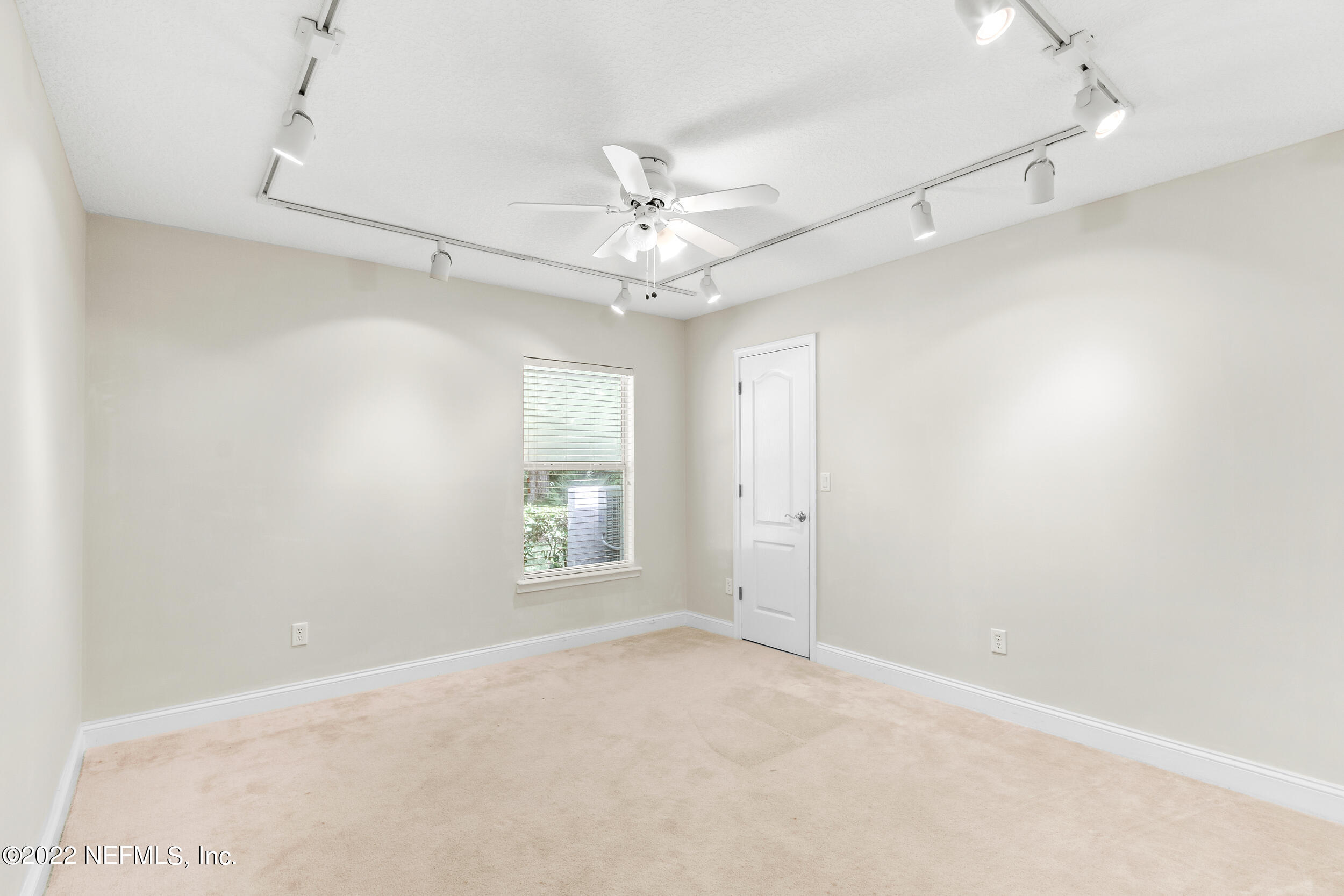 1304 Paradise Pond Road St. Augustine, FL 32092 - Photo 34 of 48 an empty room with windows and fan