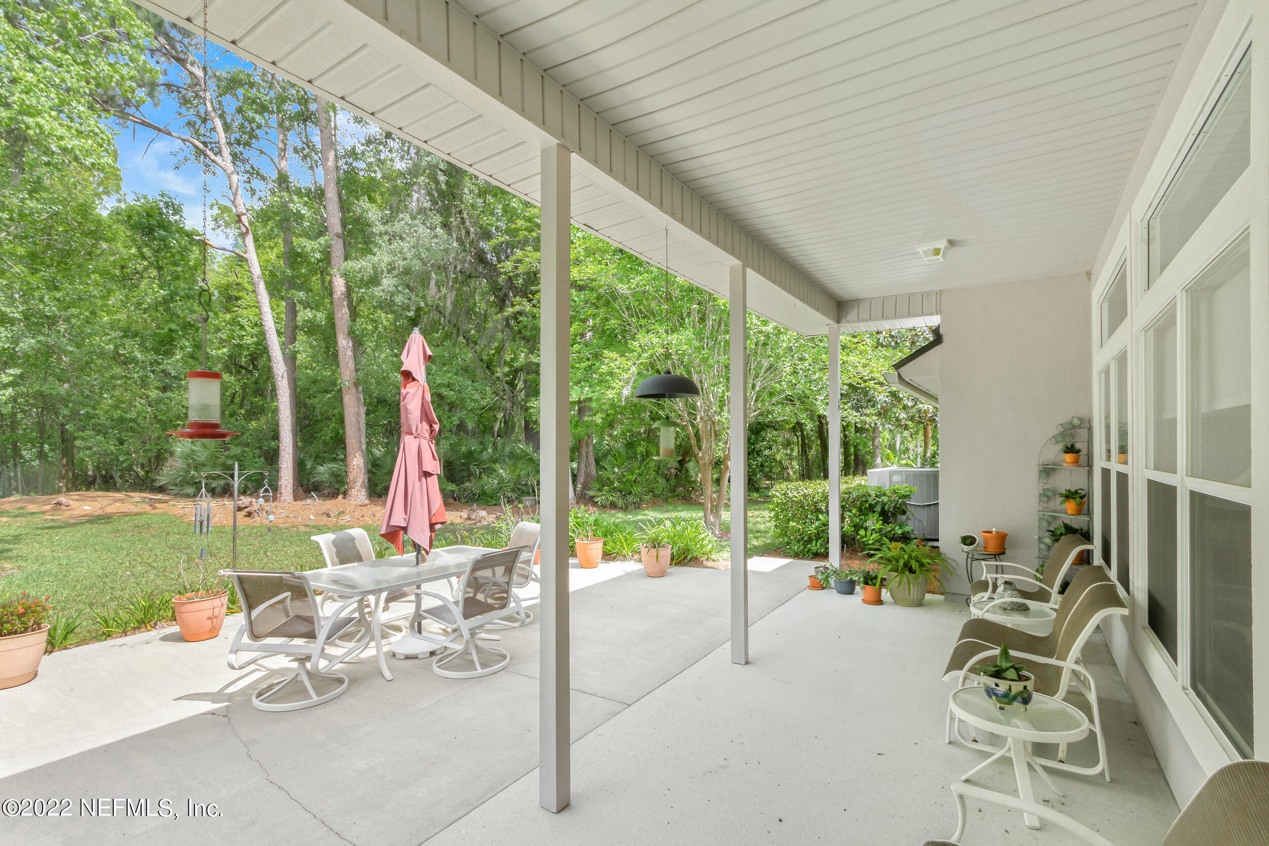 1304 Paradise Pond Road St. Augustine, FL 32092 - Photo 41 of 48 a view of a patio with a table chairs and a backyard