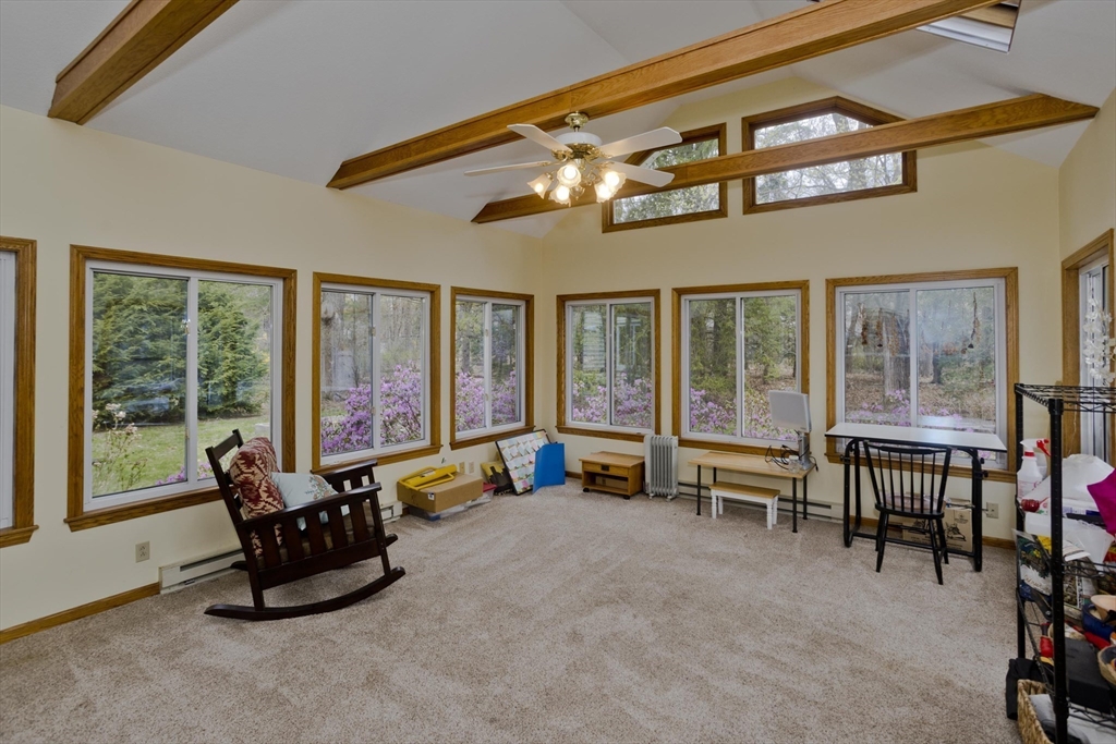 58 Longfellow Road Holyoke, MA 01040 - Photo 13 of 39 a living room with furniture a flat screen tv and floor to ceiling windows