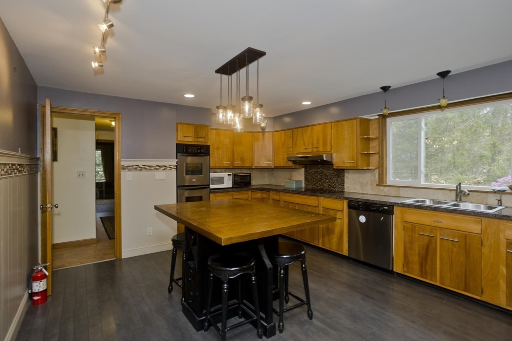 58 Longfellow Road Holyoke, MA 01040 - Photo 16 of 39 a kitchen with stainless steel appliances granite countertop wooden floor window and refrigerator