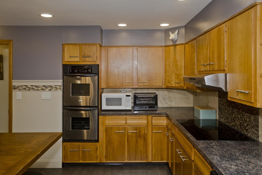 58 Longfellow Road Holyoke, MA 01040 - Photo 19 of 39 a kitchen with stainless steel appliances granite countertop a stove a sink and a microwave