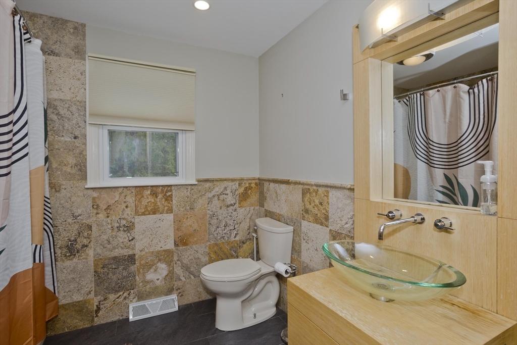 58 Longfellow Road Holyoke, MA 01040 - Photo 30 of 39 a bathroom with a sink a toilet and a mirror