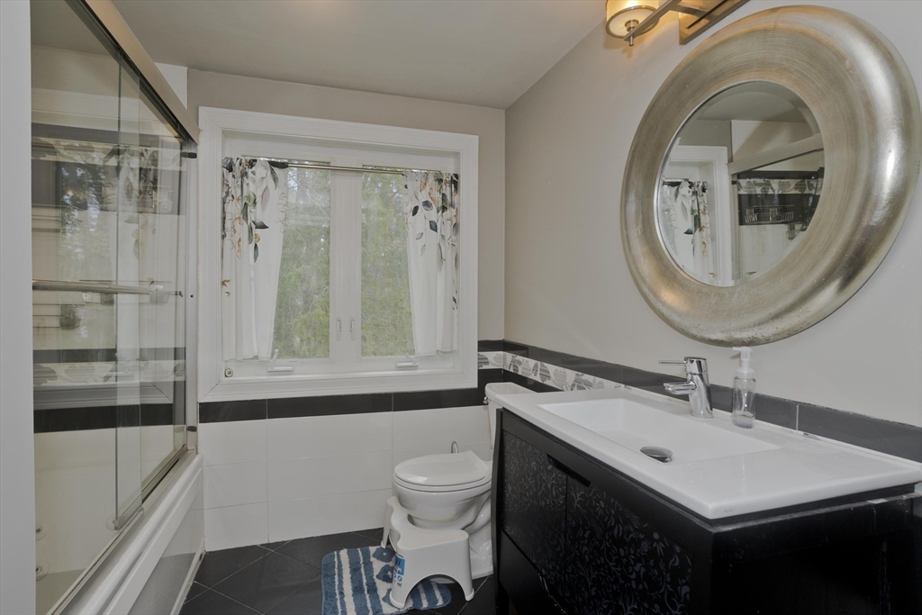 58 Longfellow Road Holyoke, MA 01040 - Photo 38 of 39 a bathroom with a sink a toilet and a mirror