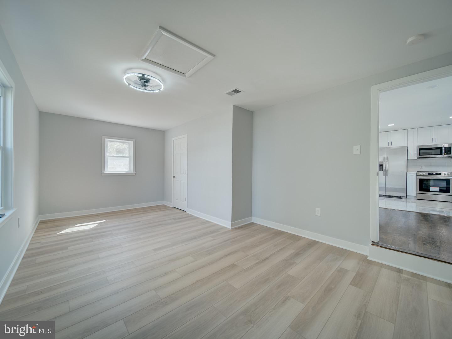 3812 Blackwater Road Clinton, MD 20735 - Photo 14 of 40 a view of empty room with wooden floor and fan