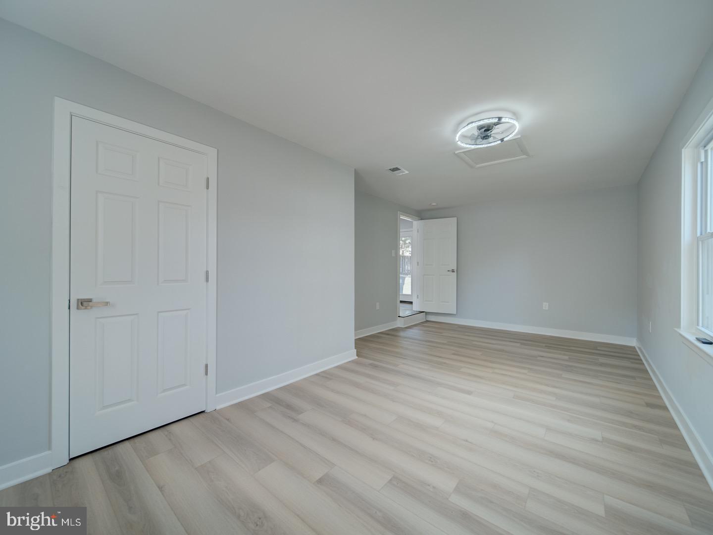 3812 Blackwater Road Clinton, MD 20735 - Photo 15 of 40 a view of an empty room with wooden floor