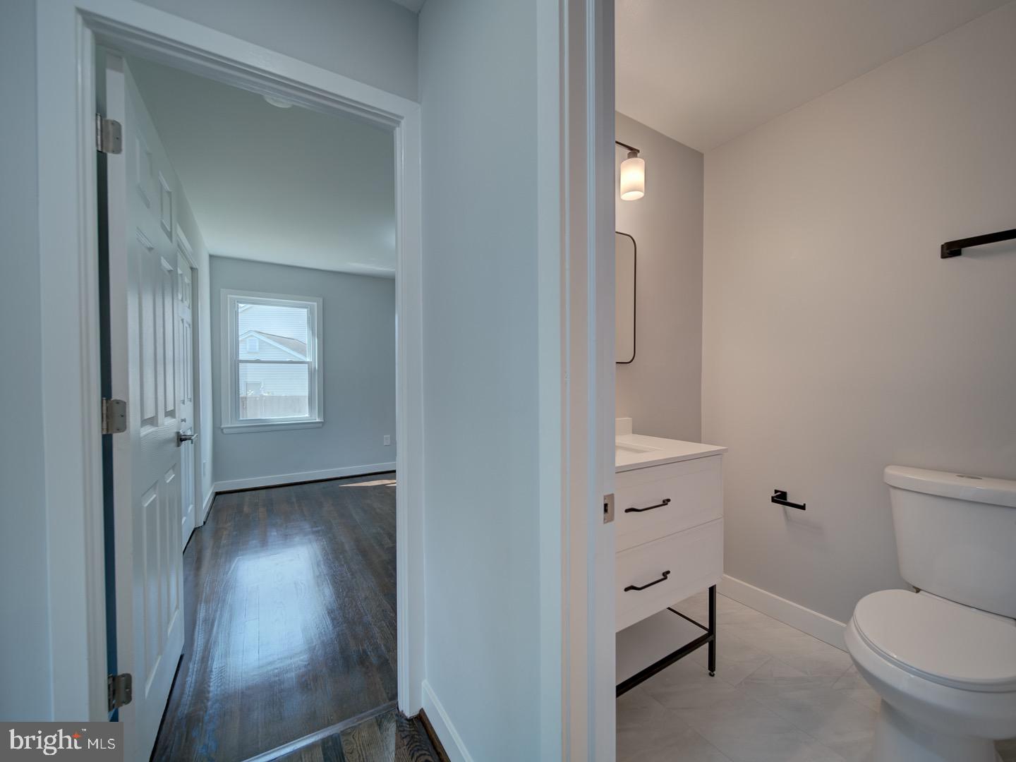 3812 Blackwater Road Clinton, MD 20735 - Photo 16 of 40 a bathroom with a toilet and a mirror