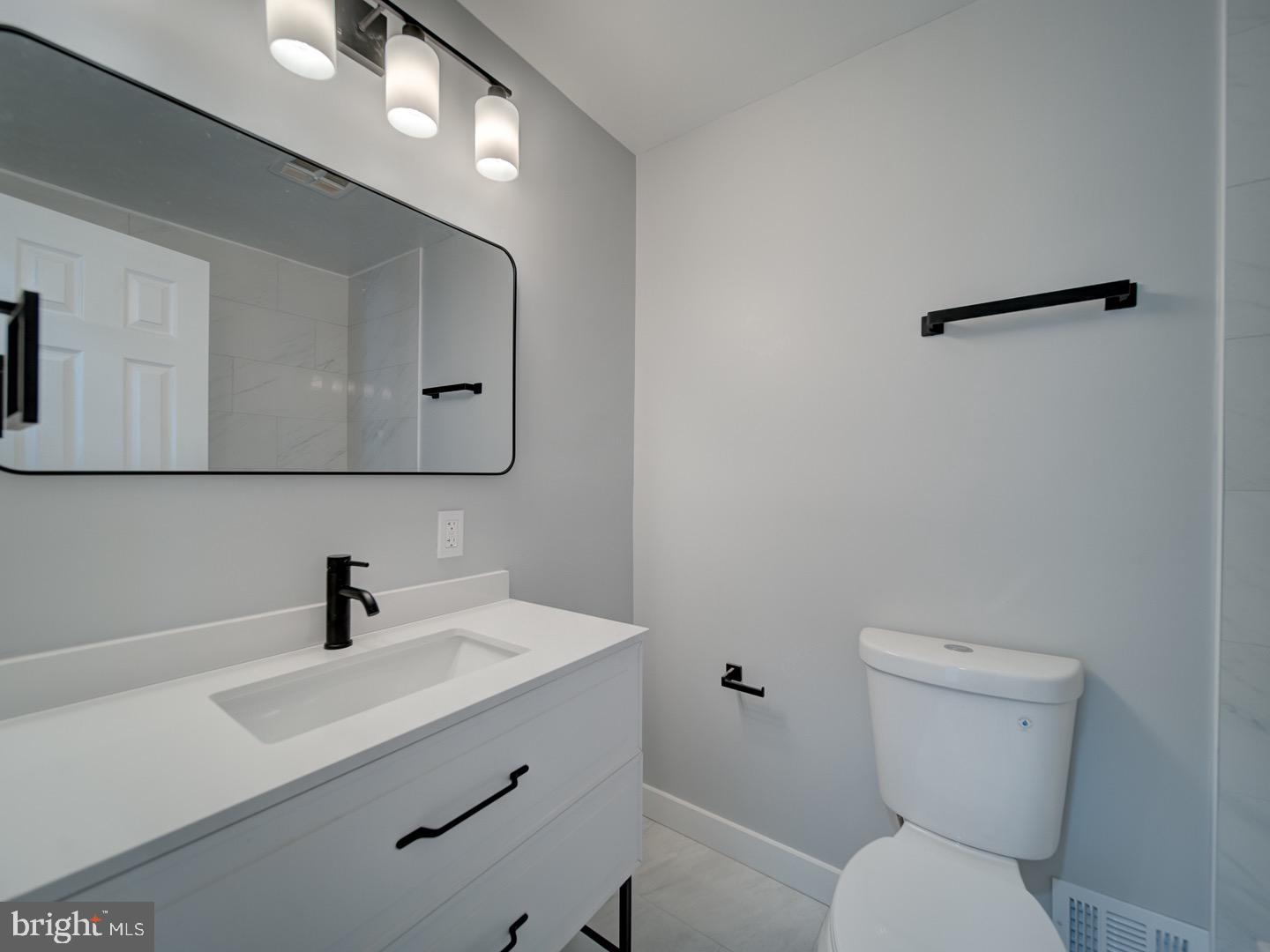 3812 Blackwater Road Clinton, MD 20735 - Photo 17 of 40 a bathroom with a toilet sink and mirror