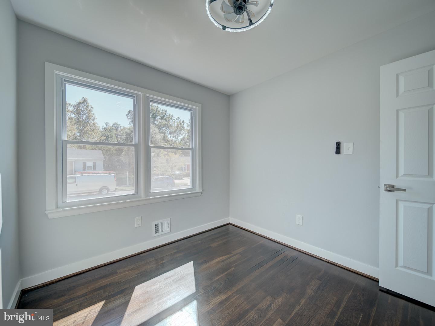 3812 Blackwater Road Clinton, MD 20735 - Photo 19 of 40 a view of an empty room with wooden floor and a window