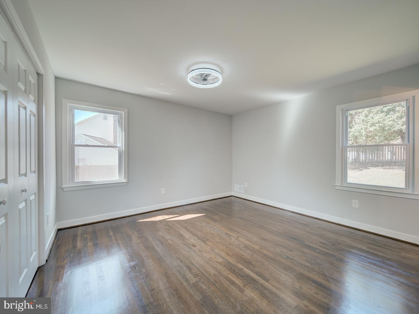 3812 Blackwater Road Clinton, MD 20735 - Photo 24 of 40 an empty room with wooden floor and windows