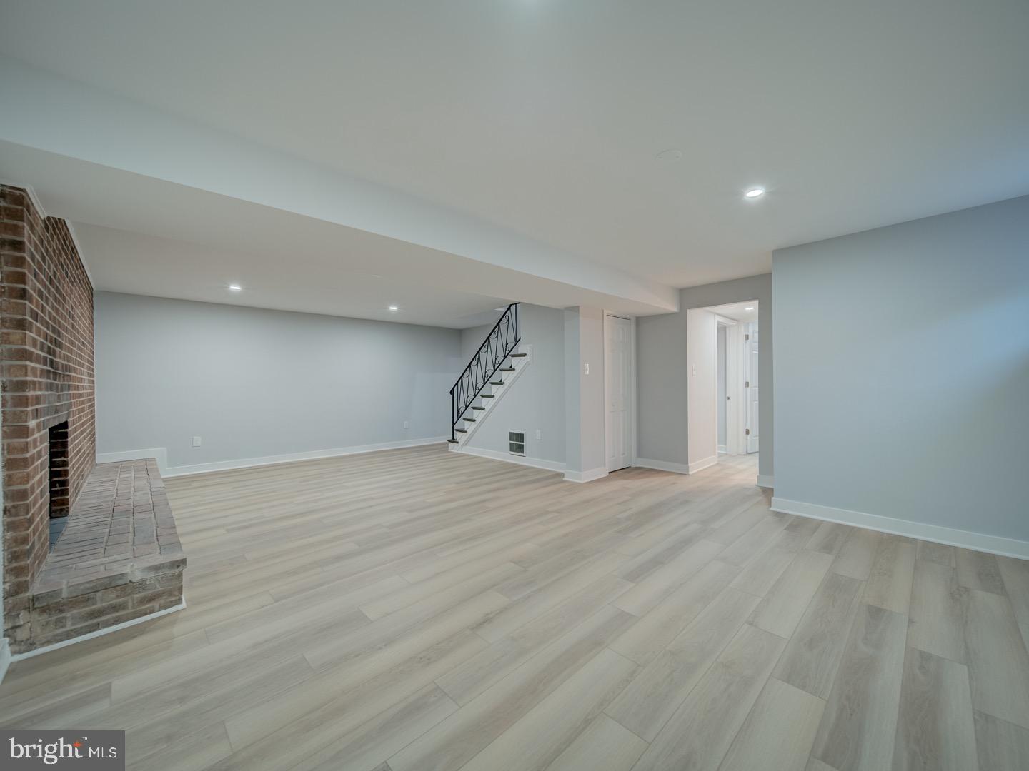 3812 Blackwater Road Clinton, MD 20735 - Photo 30 of 40 a view of an empty room with wooden floor and staircase