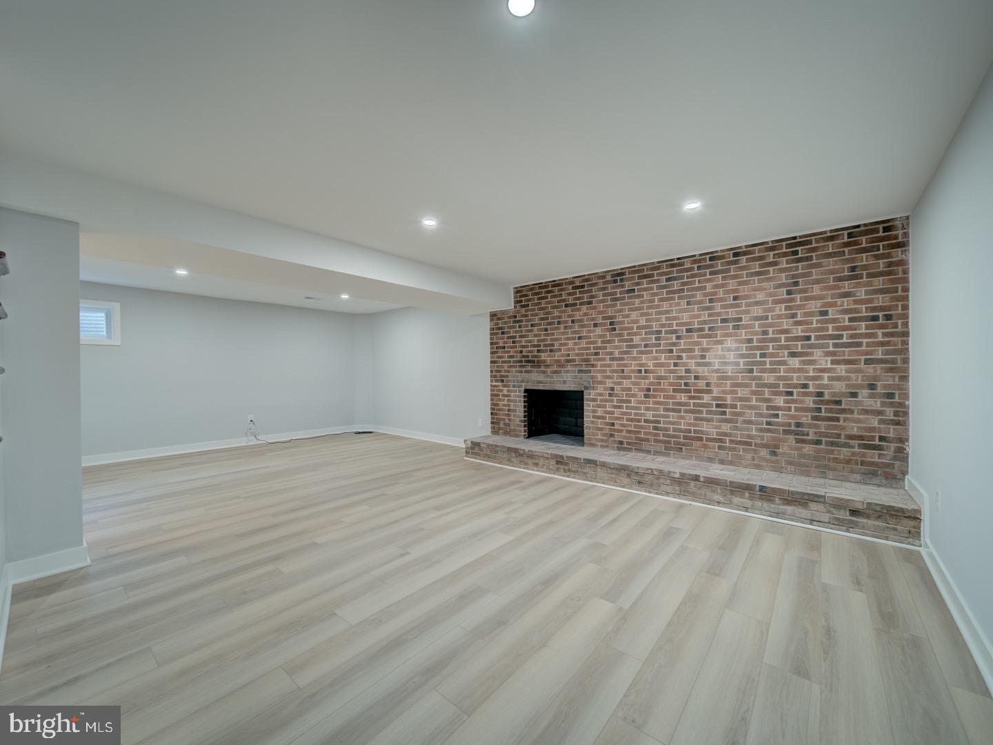 3812 Blackwater Road Clinton, MD 20735 - Photo 31 of 40 a view of empty room with wooden floor and fireplace