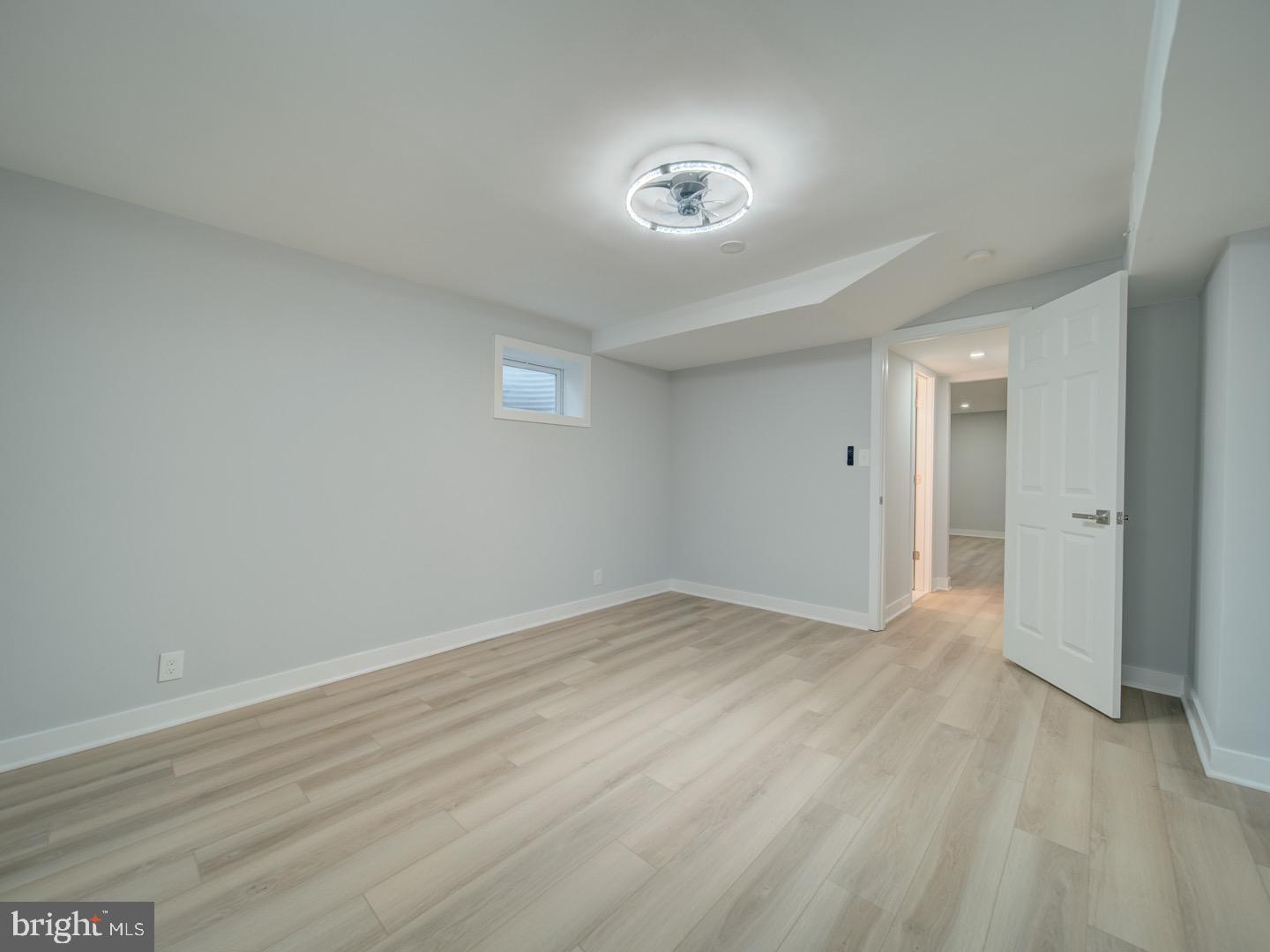 3812 Blackwater Road Clinton, MD 20735 - Photo 37 of 40 a view of an empty room with wooden floor and a window