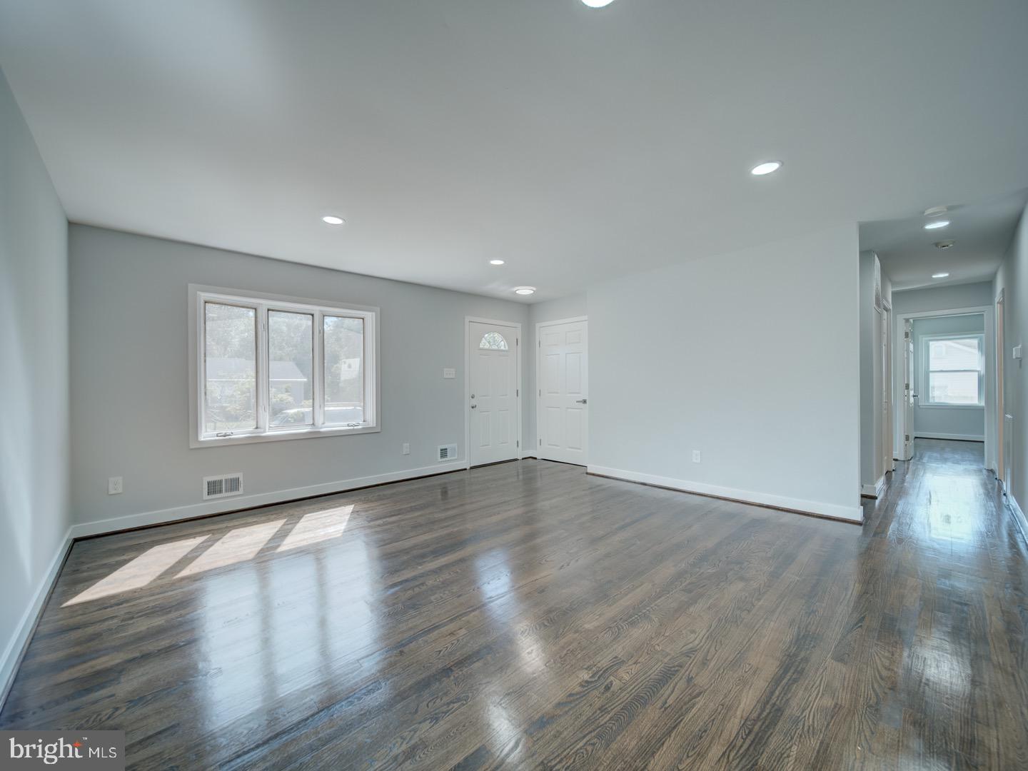 3812 Blackwater Road Clinton, MD 20735 - Photo 5 of 40 a view of an empty room with wooden floor and a window