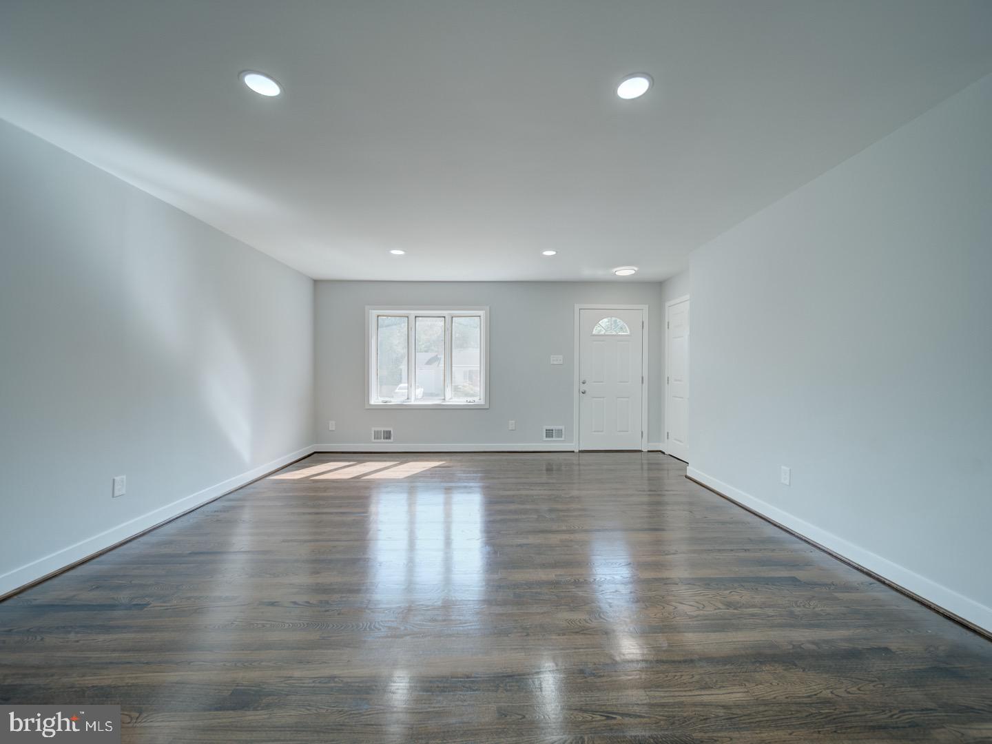3812 Blackwater Road Clinton, MD 20735 - Photo 6 of 40 an empty room with wooden floor and windows