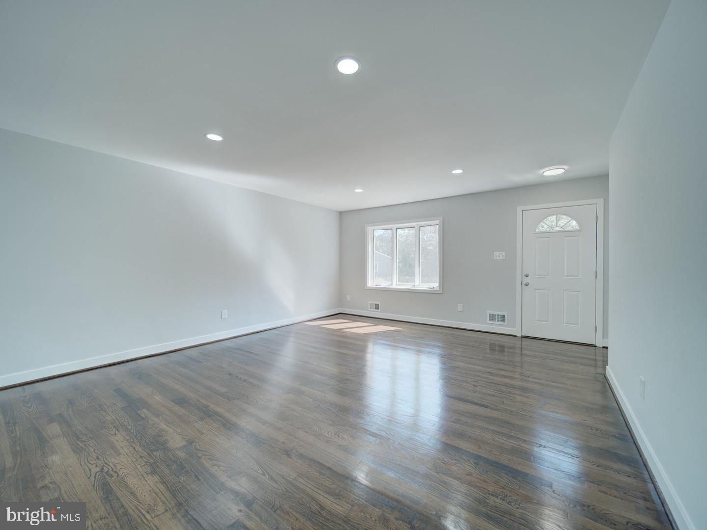 3812 Blackwater Road Clinton, MD 20735 - Photo 7 of 40 an empty room with wooden floor and windows