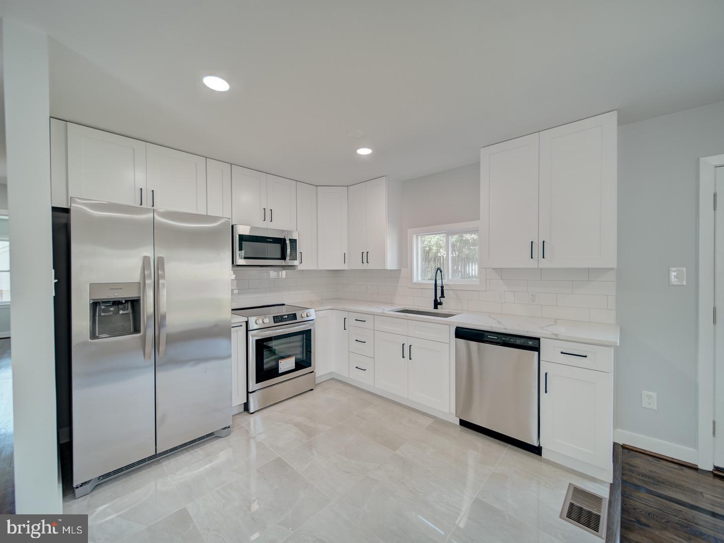 3812 Blackwater Road Clinton, MD 20735 - Photo 10 of 40 a kitchen with cabinets stainless steel appliances and a counter space