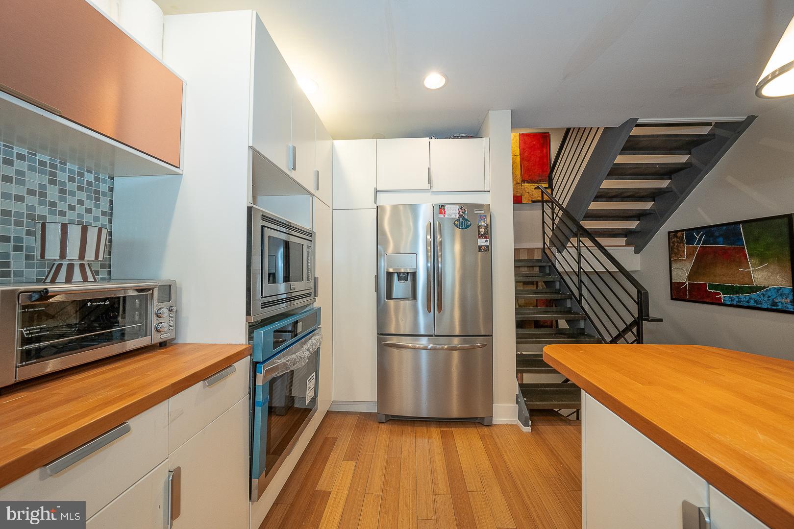 715 Shirley Street, Unit A Philadelphia, PA 19130 - Photo 8 of 24 a kitchen with stainless steel appliances a refrigerator and a stove top oven