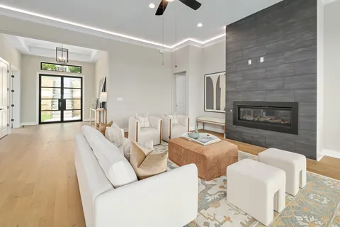 a living room with furniture a window and a fireplace