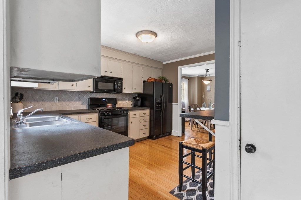 17 Columbia Road Danvers, MA 01923 - Photo 12 of 39 a kitchen with stainless steel appliances granite countertop a refrigerator and a stove top oven