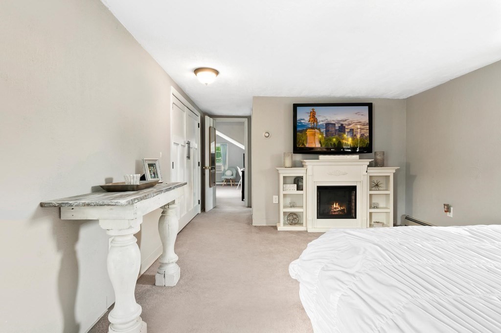 17 Columbia Road Danvers, MA 01923 - Photo 23 of 39 a spacious bedroom with a bed and a flat screen tv