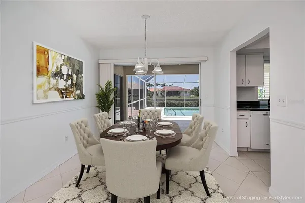 a dining room with furniture a chandelier and window