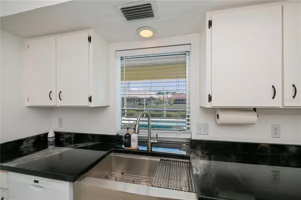 a kitchen with a sink and a stove top oven