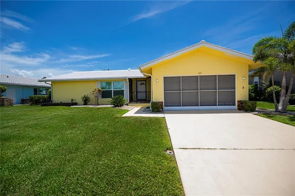 a front view of a house with a yard and garage