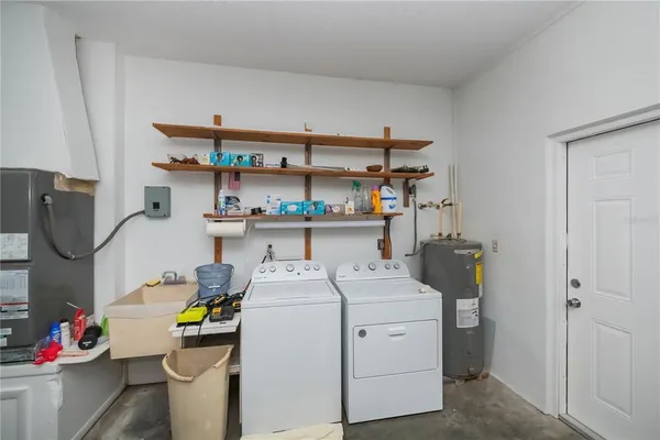 a view of a swimming pool with a table and chairs under an umbrella