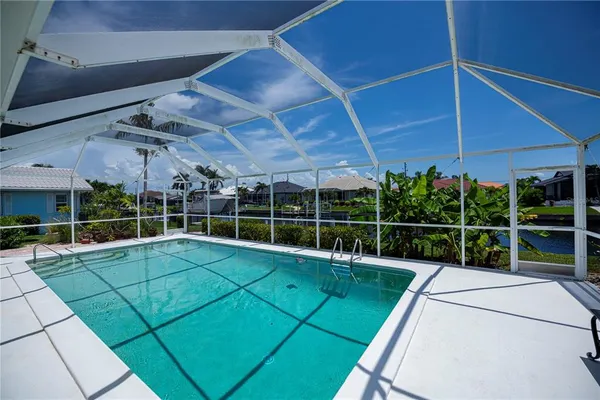 a view of a backyard with table and chairs