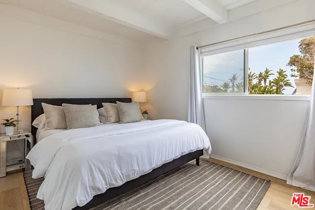 a bedroom with a bed and window