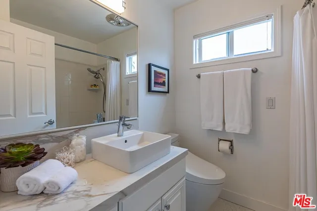 a bathroom with a sink toilet and vanity