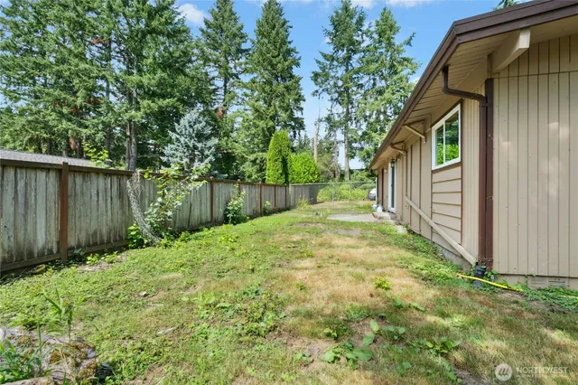 a backyard of a house with table and chairs
