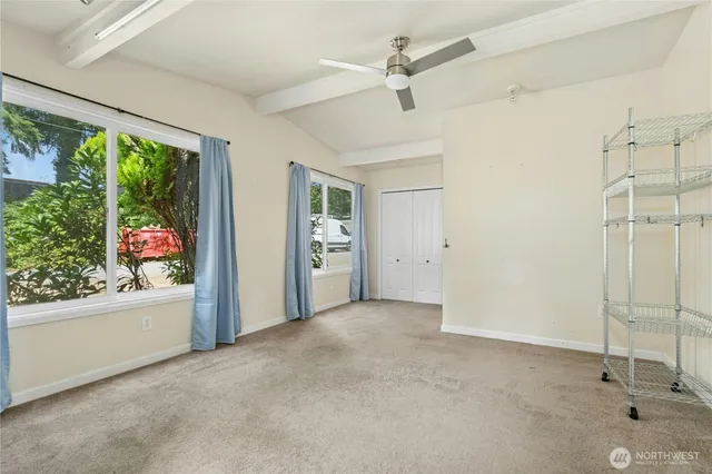 an empty room with windows and closet