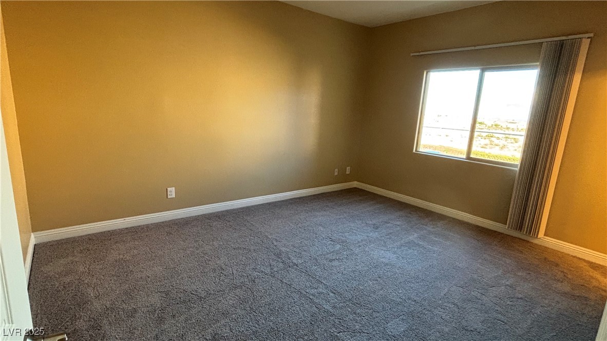 9473 Alma Ridge Avenue Las Vegas, NV 89178 - Photo 13 of 35 Carpeted empty room featuring baseboards