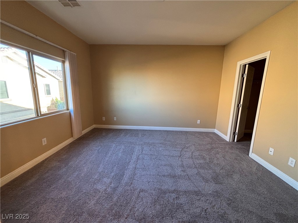 9473 Alma Ridge Avenue Las Vegas, NV 89178 - Photo 18 of 35 Empty room featuring dark colored carpet and baseboards
