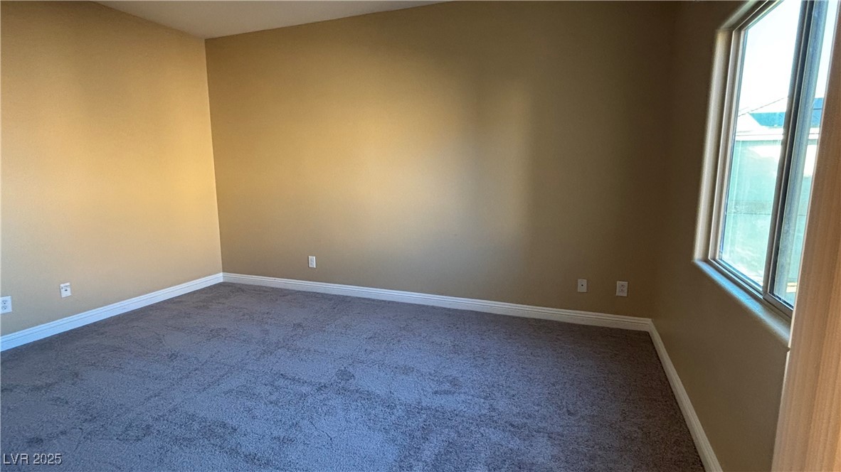 9473 Alma Ridge Avenue Las Vegas, NV 89178 - Photo 19 of 35 Unfurnished room featuring baseboards and carpet flooring