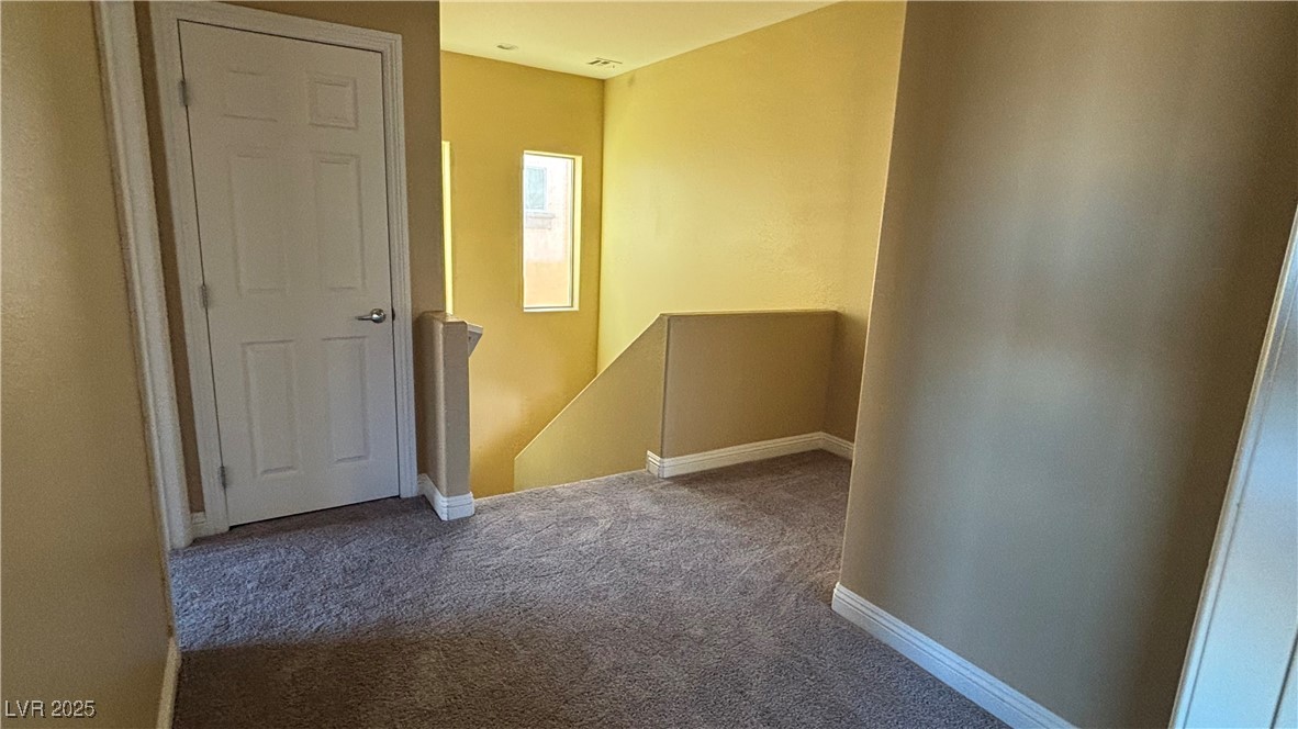 9473 Alma Ridge Avenue Las Vegas, NV 89178 - Photo 24 of 35 Hallway featuring an upstairs landing and carpet