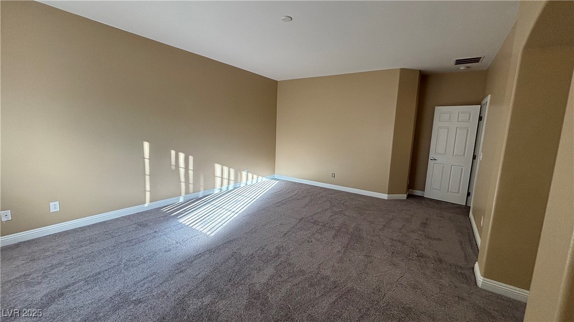 9473 Alma Ridge Avenue Las Vegas, NV 89178 - Photo 30 of 35 Carpeted spare room with baseboards