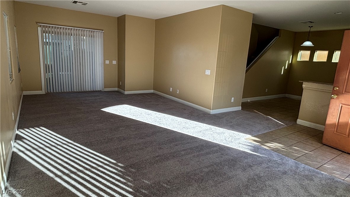9473 Alma Ridge Avenue Las Vegas, NV 89178 - Photo 5 of 35 Tiled spare room featuring carpet floors and baseboards