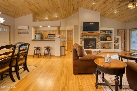a living room with fireplace furniture and a flat screen tv