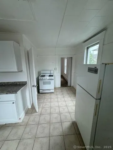 a room with a stove top oven and cabinets