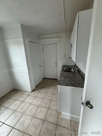 a view of a utility room with cabinets