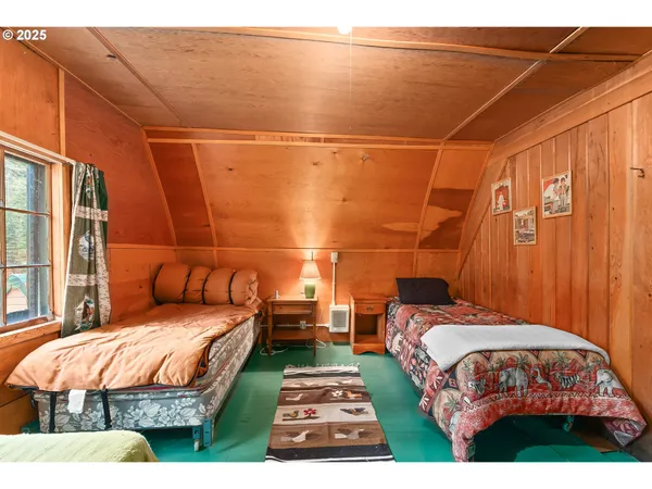 a bedroom with a bed and a tv