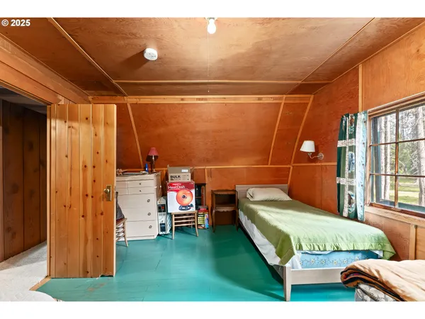 a bedroom with bed and window