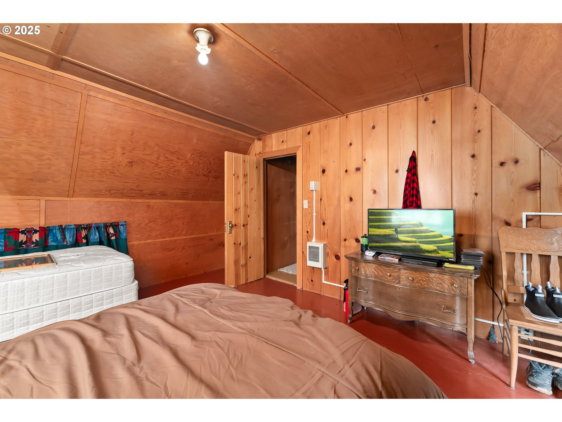 85 Diamond Lake Loop Chemult, OR 97731 - Photo 26 of 40 a bedroom with a bed and wooden floor