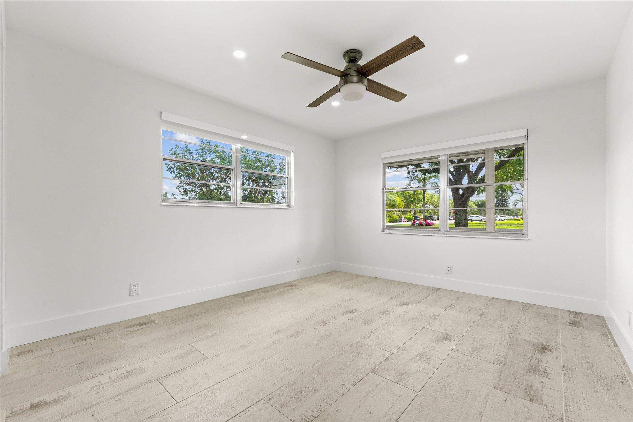 308 Preston H, Unit 308 Boca Raton, FL 33434 - Photo 16 of 22 an empty room with windows and fan