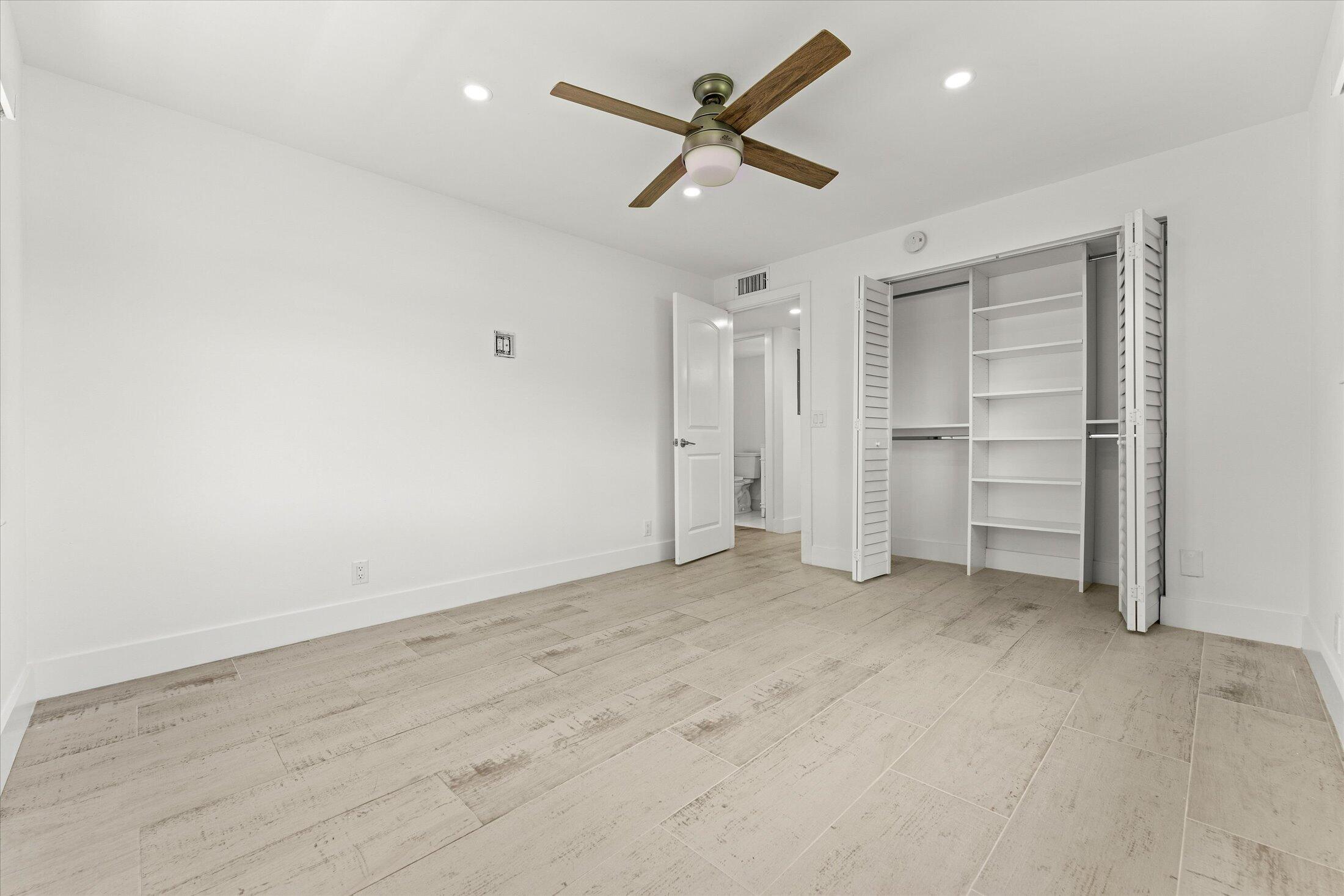 308 Preston H, Unit 308 Boca Raton, FL 33434 - Photo 17 of 22 an empty room with closet and windows