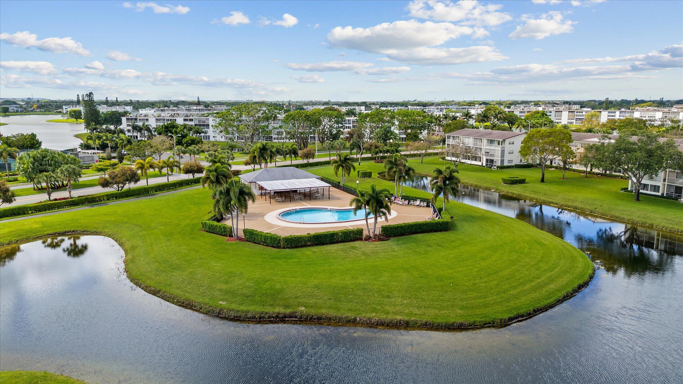 308 Preston H, Unit 308 Boca Raton, FL 33434 - Photo 21 of 22 a view of a swimming pool with a garden