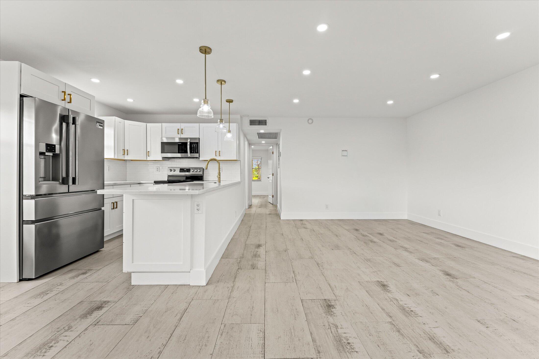 308 Preston H, Unit 308 Boca Raton, FL 33434 - Photo 3 of 22 a kitchen with stainless steel appliances a refrigerator sink and microwave